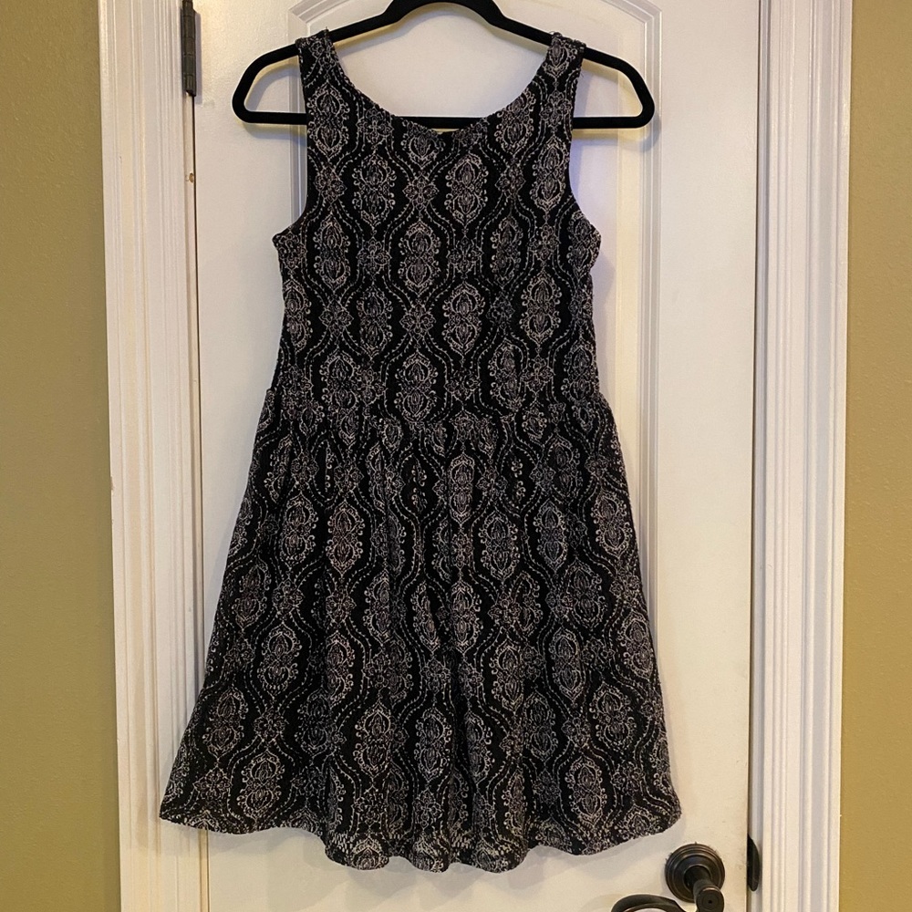 A line sleeveless dress. Black and white with lace overlay.